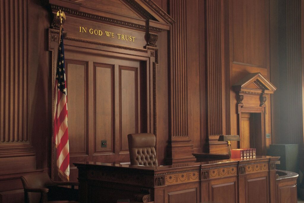 Empty judge's bench in ornate wooden courtroom